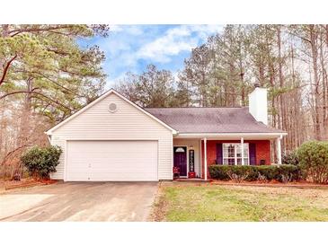 Charming single-story home with a manicured lawn, two-car garage, and inviting entrance at 122 Lakepointe Court Ct, Stockbridge, GA 30281