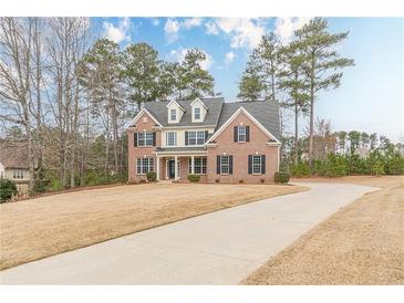 Charming two-story brick home with black shutters, dormer windows, and a spacious front lawn at 190 Holcomb Ct, Fayetteville, GA 30215