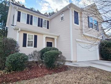 Charming two-story home featuring a two-car garage, black shutters, and a well-maintained lawn at 3160 Sable Trl, Atlanta, GA 30349