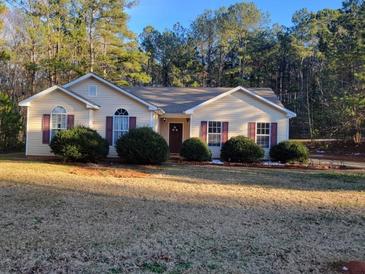 Charming one-story home featuring a well-maintained yard and inviting curb appeal with classic design and mature landscaping at 104 Worthy Drive, Mcdonough, GA 30252