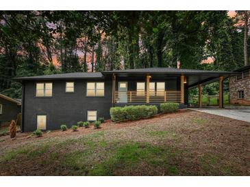 Charming exterior featuring a large, covered front porch and freshly painted brick at 2210 Bolling Brook Sw Dr, Atlanta, GA 30311