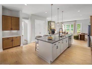 Bright kitchen features a large island with seating, modern appliances, and an open floor plan at 1424 Wicker Wood Se Pl # 7, Smyrna, GA 30080