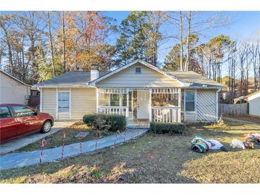 Charming single-story home with stone accents, a welcoming porch, and holiday decorations at 3109 Meadow Wood Ct, Lawrenceville, GA 30044