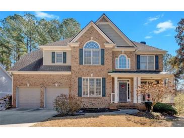 Charming two-story brick home featuring a two-car garage and welcoming front porch at 79 Nimblewood Trl, Acworth, GA 30101