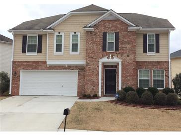 Charming two-story home featuring a brick facade, attached two-car garage, and well-manicured front yard at 2098 Cutleaf Creek Rd, Grayson, GA 30017