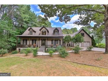 Charming two-story home boasts a welcoming front porch and lush, mature landscaping at 1230 Mars Hill Nw Rd, Acworth, GA 30101