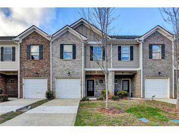 Charming townhome with brick and siding facade, attached garages, and well-maintained landscaping at 1797 Old Dogwood, Jonesboro, GA 30238