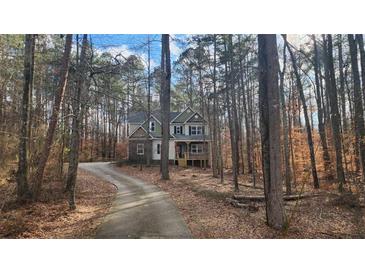 Charming two-story home nestled among trees, offering a secluded and private setting at 488 Morris Rd, Hiram, GA 30141