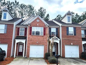 Charming brick townhouse with attached garage and well-maintained landscaping at 3893 Dandridge Way, Duluth, GA 30096