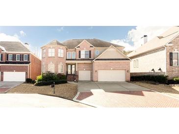 Traditional brick home with a two-car garage and well-manicured landscaping at 2322 Norbury Se Cv, Smyrna, GA 30080