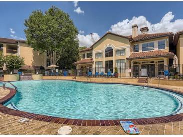 Beautiful pool surrounded by lush landscaping and a well-maintained apartment complex on a bright, sunny day at 3777 Peachtree Ne Rd # 1324, Brookhaven, GA 30319