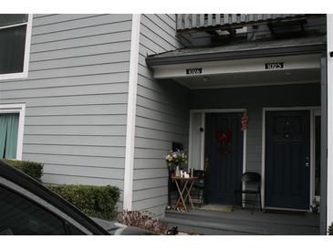 Two-story home featuring side-by-side front doors and neutral siding for a cozy neighborhood living at 1026 Riverbend Club Se Dr, Atlanta, GA 30339