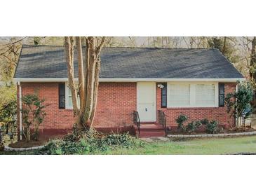 Charming brick home featuring a well-maintained lawn and inviting front entrance at 2413 Hillside Ave, Decatur, GA 30032