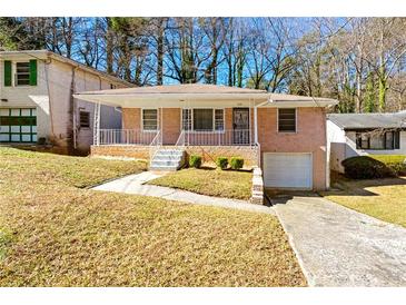 Charming brick home featuring a well-manicured front yard, a driveway, and mature trees at 664 Church Nw St, Atlanta, GA 30318