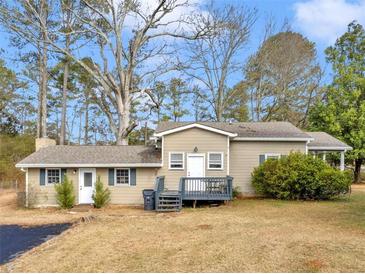 Charming single-story home featuring a cozy front porch and a well-maintained lawn at 583 Mount Zion Rd, Oxford, GA 30054
