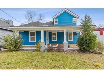 Charming two-story home featuring blue siding, inviting front porch and manicured front yard at 1598 Jonesboro Se Rd, Atlanta, GA 30315