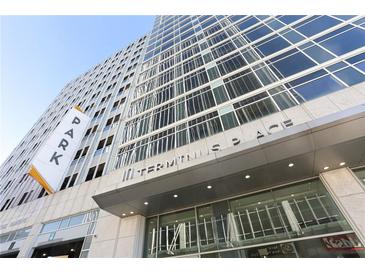 Exterior view of Terminus Place showing large windows, a parking sign, and the building's street-facing entrance at 3325 Piedmont Ne Rd # 1502, Atlanta, GA 30326