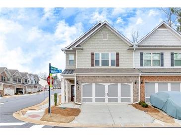 Charming townhome featuring a two-car garage and well-maintained landscaping in a desirable community at 539 Walton Dr, Woodstock, GA 30188