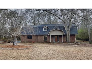 Charming two-story brick home featuring a classic design and well-maintained landscaping in a natural setting at 250 Southmoor Cir, Stockbridge, GA 30281