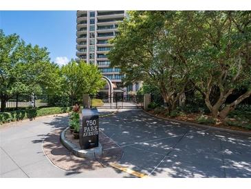 View of the building's gated entrance on a sunny day at 750 Park Ne Ave # 21E, Atlanta, GA 30326