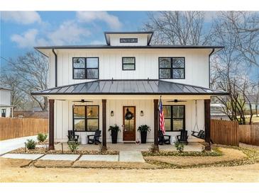 Charming two-story modern farmhouse with a welcoming front porch and beautiful landscaping at 1751 Stanwood Se Ave, Atlanta, GA 30317