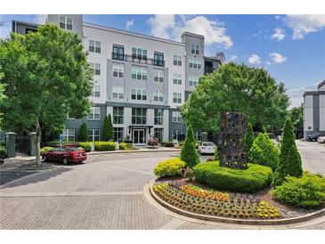 Beautiful building with lush landscaping and a circular driveway providing an attractive entrance at 747 Ralph Mcgill Ne Blvd # 326, Atlanta, GA 30312