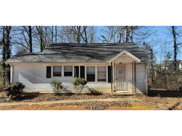 Modest single story home featuring a compact front porch, classic windows, and a mature yard at 2305 Phillips Rd, Lithonia, GA 30058