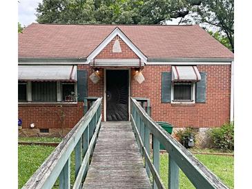 Charming brick home featuring a unique walkway, awning-covered windows and front door at 2628 Northview Ave, Decatur, GA 30032