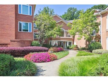 Beautiful building exterior with colorful flower beds and a walkway leading to the entrance at 5306 Brooke Ridge Dr, Atlanta, GA 30338