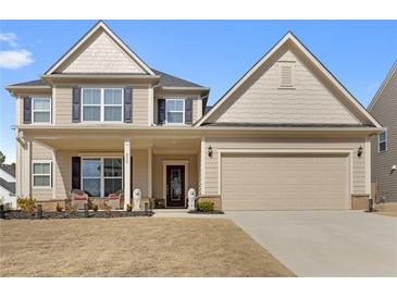 Inviting two-story home featuring a covered porch, neutral siding, and an attached two-car garage at 250 Riverclub Rd, Acworth, GA 30101