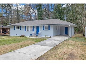 Charming single-story home featuring a long driveway and blue accents at 470 Oriole Dr, Marietta, GA 30067
