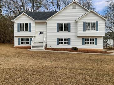 Charming white two-story home with blue shutters and well-maintained front yard at 17 Cedars Glen Pl, Villa Rica, GA 30180