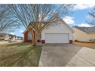Charming single Gathering home with an attached garage and well-manicured lawn at 2612 Kirkhill Ct, Lawrenceville, GA 30044