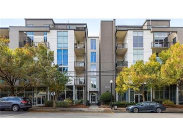 Modern condo building exterior with a symmetrical design, large windows, and well-maintained landscaping at 3400 Malone Dr # 303, Atlanta, GA 30341