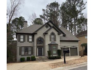 Charming two-story home with a well-maintained yard and two-car garage at 911 Laurel Crest Dr, Woodstock, GA 30189