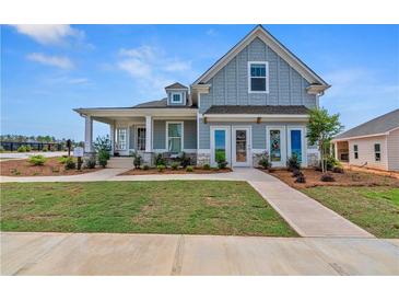 Charming two-story home with a welcoming front porch and nicely landscaped front yard at 81 Heritage Pointe Dr, Villa Rica, GA 30180