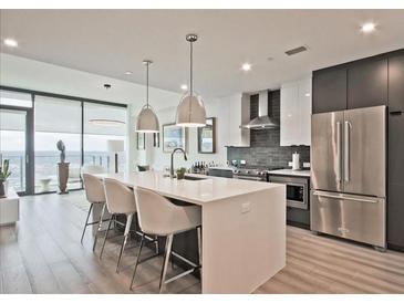 Modern kitchen with a large island, stainless steel appliances, and pendant lighting at 788 W Marietta Nw St # 913, Atlanta, GA 30318