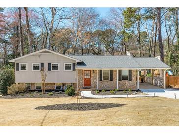 Charming single-Gathering home featuring a well-maintained lawn, brick accents, and a convenient carport at 4122 Antler Se Trl, Smyrna, GA 30082