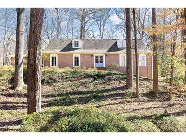 Charming brick home featuring a classic design and mature trees at 4095 Glen Devon Nw Dr, Atlanta, GA 30327