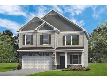 Charming two-story home featuring stone accents, neutral siding, and a two-car garage, set against a blue sky at 174 Silver Leaf Trl, Douglasville, GA 30134