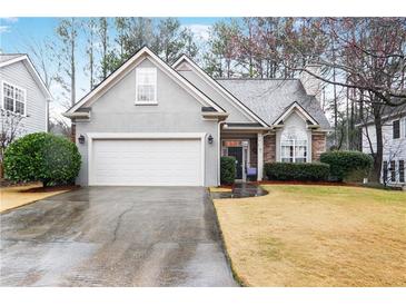 Charming single-Gathering home featuring a two-car garage and well-manicured front yard at 2160 Berryhill Se Cir, Smyrna, GA 30082