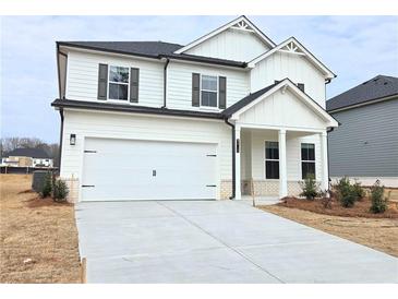 Two-story home boasts a white exterior, a two-car garage, and a well-manicured lawn at 2369 Brown Dove (Lot 3) Way, Grayson, GA 30017