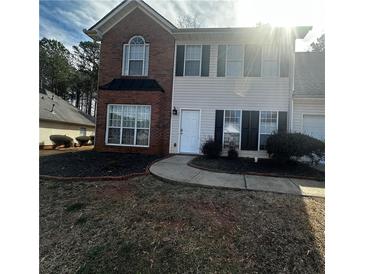 Charming two-story home features a brick and vinyl facade, well-maintained lawn, and inviting curb appeal at 12264 Crestwood Ct, Fayetteville, GA 30215