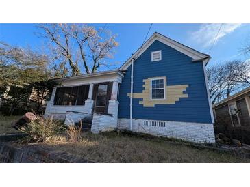 Exterior view of a two-story home with a screened-in porch and blue siding at 884 Mcdaniel Sw St, Atlanta, GA 30310