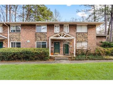 Charming brick and stone townhouse with covered entrance and well-maintained landscaping at 2412 Peachwood Circle Northeast Ne Cir # 3, Atlanta, GA 30345