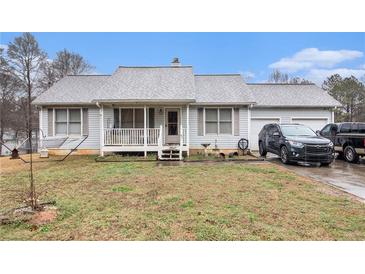 Charming single-story home with a welcoming front porch and attached two-car garage at 160 Wesley Chapel Rd, Villa Rica, GA 30180