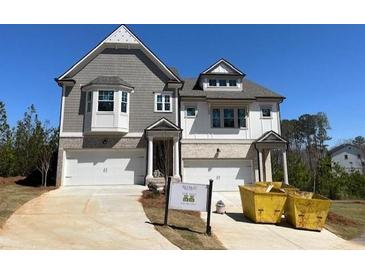 New two-story home with gray and white facade and two-car garage at 201 Retreat Ln, Canton, GA 30114