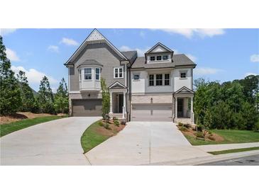 Charming two-story townhome with manicured lawn, private driveways and attached two car garage at 201 Retreat Ln, Canton, GA 30114