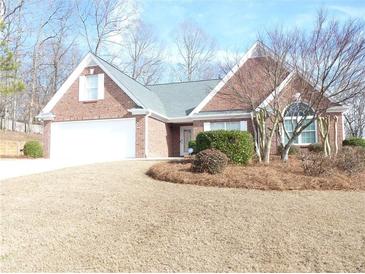 Charming one-story brick home with manicured lawn and attached two-car garage at 735 Sunset Ridge Ln, Lawrenceville, GA 30045