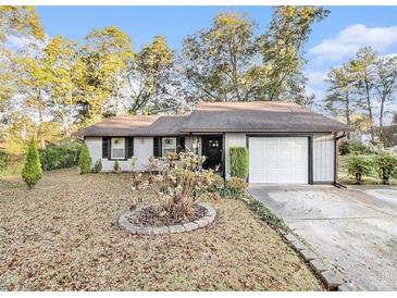 Charming single-story home featuring a well-maintained lawn, attached garage, and inviting front entrance at 2057 Bixler Cir, Decatur, GA 30032